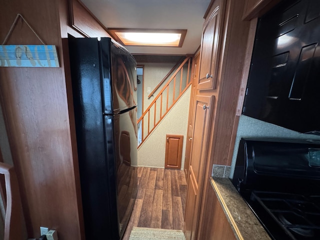 1540 US Highway 59 Unit 203, Detroit Lakes, MN 56501 - kitchen featuring freestanding refrigerator, wood finished floors, and brown cabinets