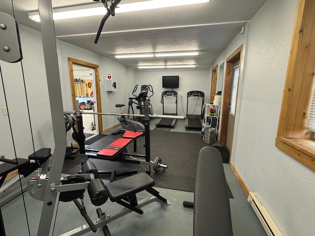 1540 US Highway 59 Unit 203, Detroit Lakes, MN 56501 - workout area with a textured wall, a textured ceiling, and a baseboard heating unit