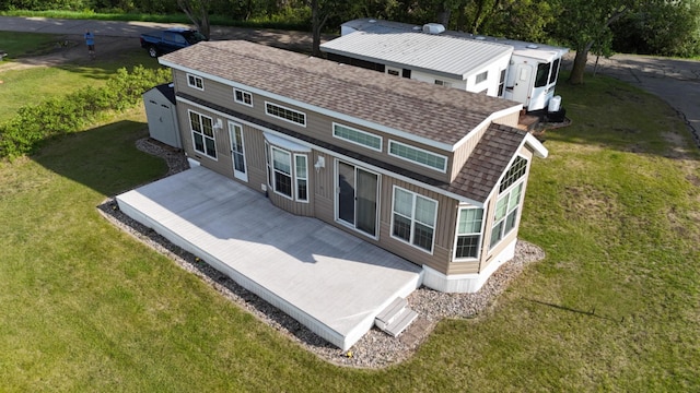 1540 US Highway 59 Unit 203, Detroit Lakes, MN 56501 - back of house featuring a shingled roof and a yard