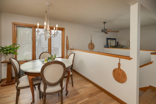 4887 Tee Ct SW, Rochester, MN 55902 - dining area featuring ceiling fan, light wood finished floors, a chandelier, and a textured ceiling