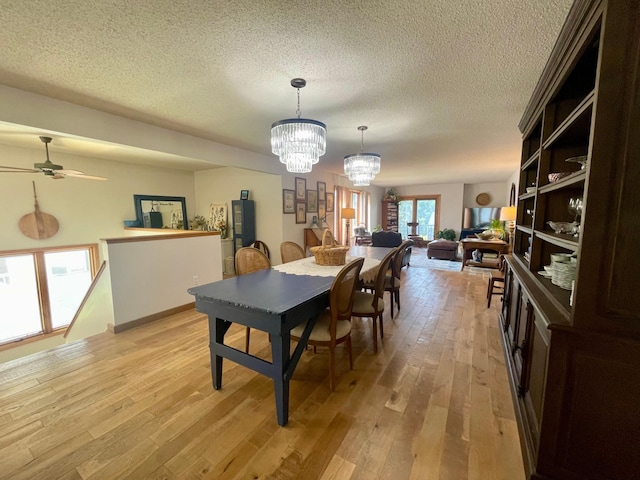 4887 Tee Ct SW, Rochester, MN 55902 - dining space with a chandelier, light wood finished floors, a textured ceiling, and a ceiling fan