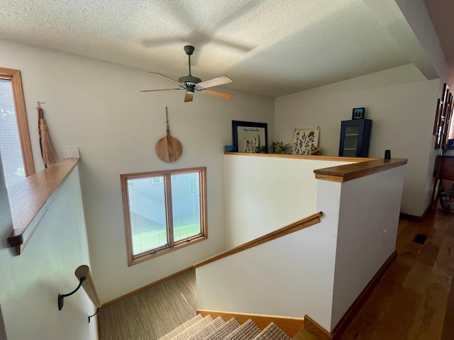 4887 Tee Ct SW, Rochester, MN 55902 - staircase featuring ceiling fan, a textured ceiling, and wood finished floors
