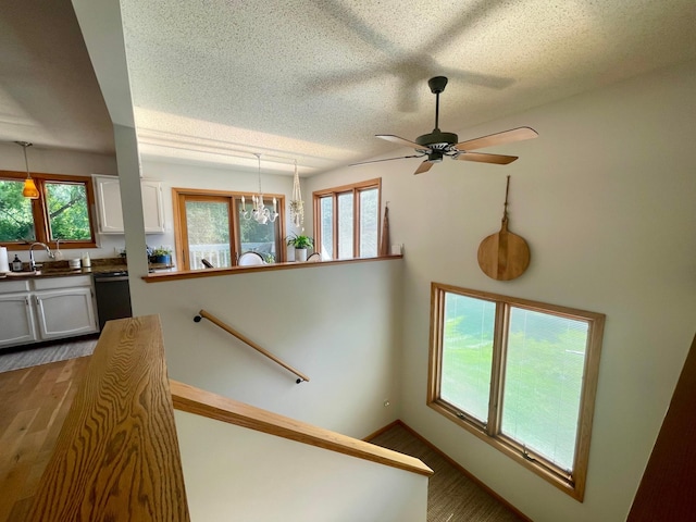 4887 Tee Ct SW, Rochester, MN 55902 - staircase with a textured ceiling and ceiling fan