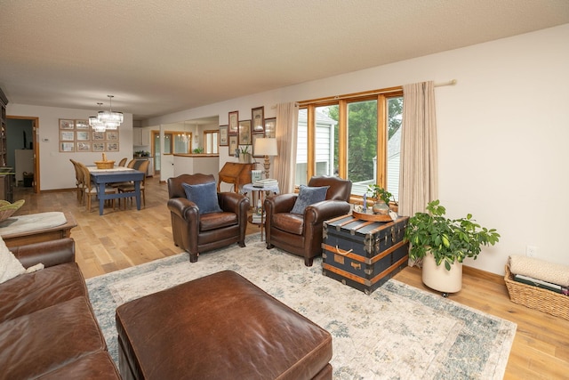 4887 Tee Ct SW, Rochester, MN 55902 - living room featuring a chandelier and wood finished floors