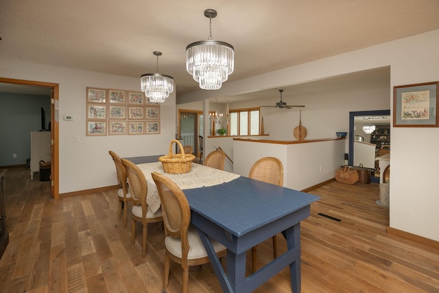 4887 Tee Ct SW, Rochester, MN 55902 - dining area featuring a chandelier, wood finished floors, and ceiling fan