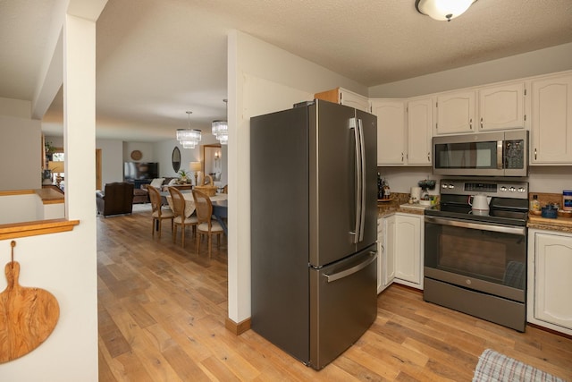 4887 Tee Ct SW, Rochester, MN 55902 - kitchen with appliances with stainless steel finishes, light wood-style flooring, and white cabinets