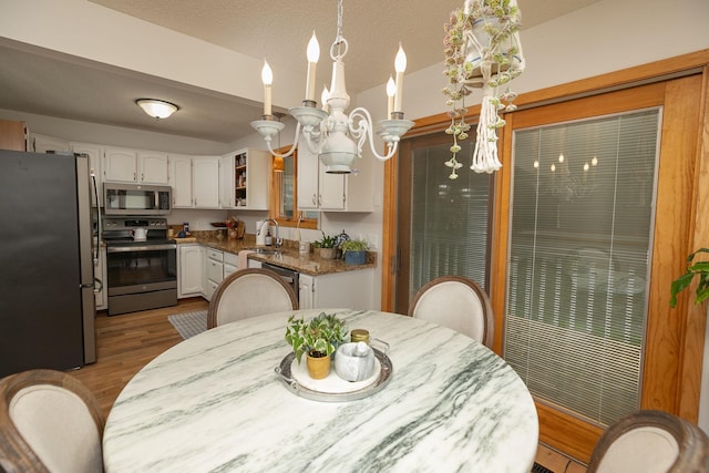 4887 Tee Ct SW, Rochester, MN 55902 - dining space with wood finished floors and a chandelier