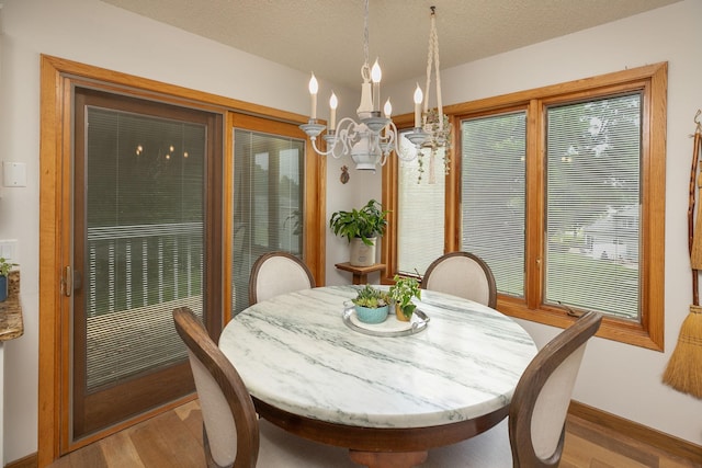 4887 Tee Ct SW, Rochester, MN 55902 - dining area featuring a chandelier and light wood-type flooring