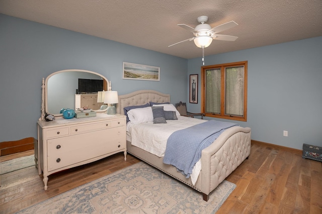 4887 Tee Ct SW, Rochester, MN 55902 - bedroom with wood finished floors, a ceiling fan, and a textured ceiling