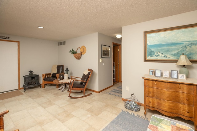 4887 Tee Ct SW, Rochester, MN 55902 - living area featuring a wood stove, a textured ceiling, and recessed lighting