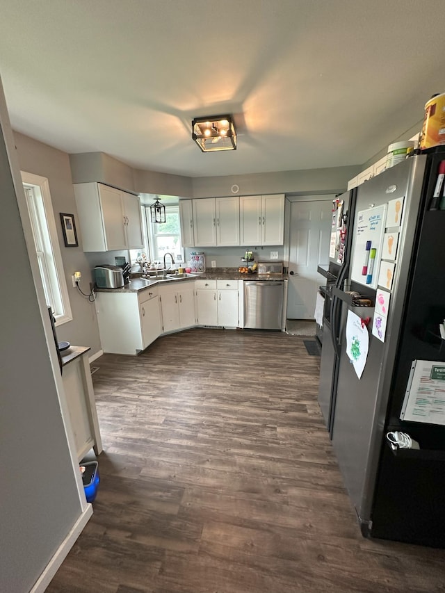 15729 232nd Ave NE, Hawick, MN 56273 - kitchen with stainless steel appliances, white cabinets, and dark wood-style floors