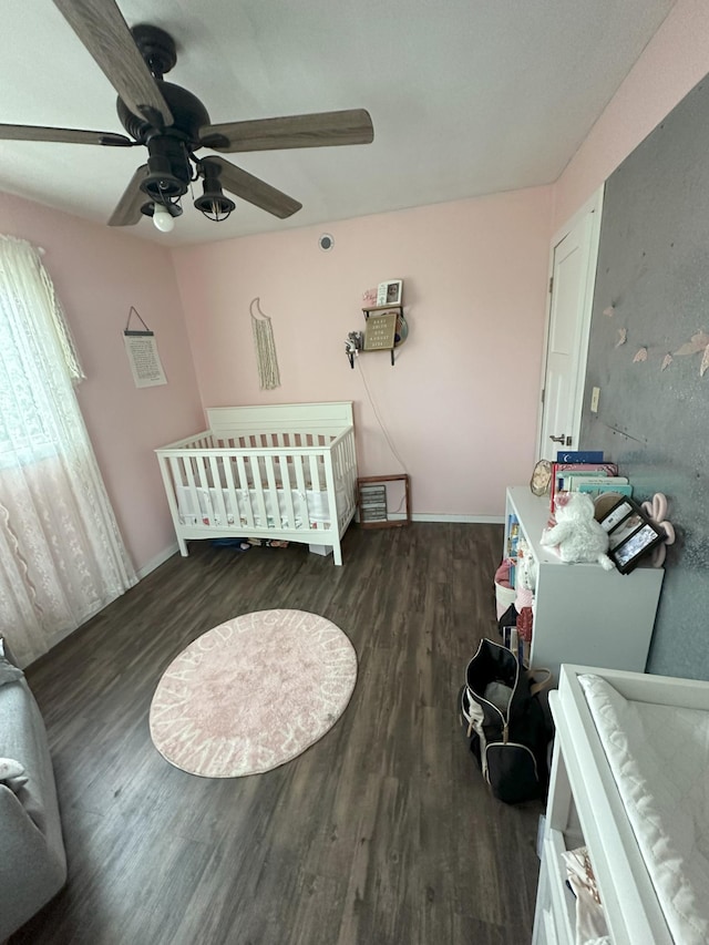 15729 232nd Ave NE, Hawick, MN 56273 - bedroom featuring wood finished floors, ceiling fan, and a nursery area