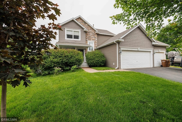 6354 151st Street Ct N, Hugo, MN 55038 - view of front of home with asphalt driveway, a front lawn, a garage, and stone siding