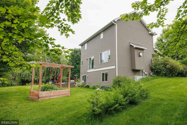 6354 151st Street Ct N, Hugo, MN 55038 - view of property exterior featuring a yard and a vegetable garden