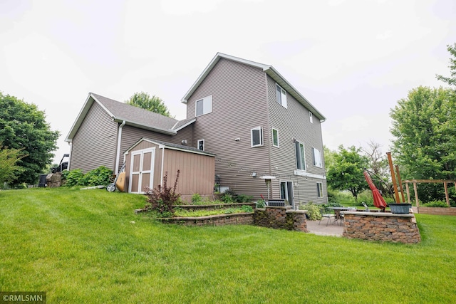 6354 151st Street Ct N, Hugo, MN 55038 - rear view of house with a storage shed, a patio, a lawn, and a fire pit