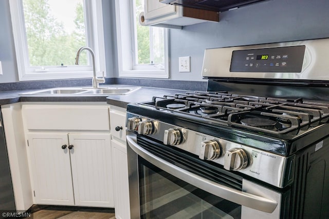 6354 151st Street Ct N, Hugo, MN 55038 - kitchen featuring stainless steel gas stove, white cabinetry, and dark countertops