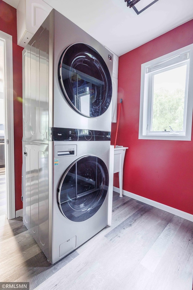 6354 151st Street Ct N, Hugo, MN 55038 - laundry room featuring estacked washer and dryer and wood finished floors