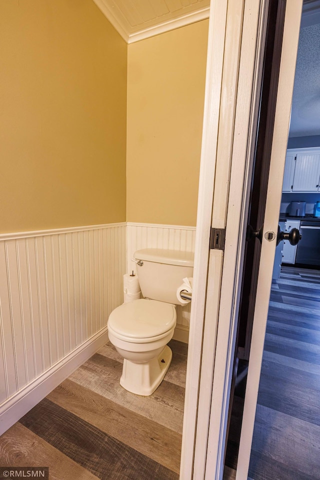 6354 151st Street Ct N, Hugo, MN 55038 - bathroom with wainscoting, wood finished floors, and ornamental molding