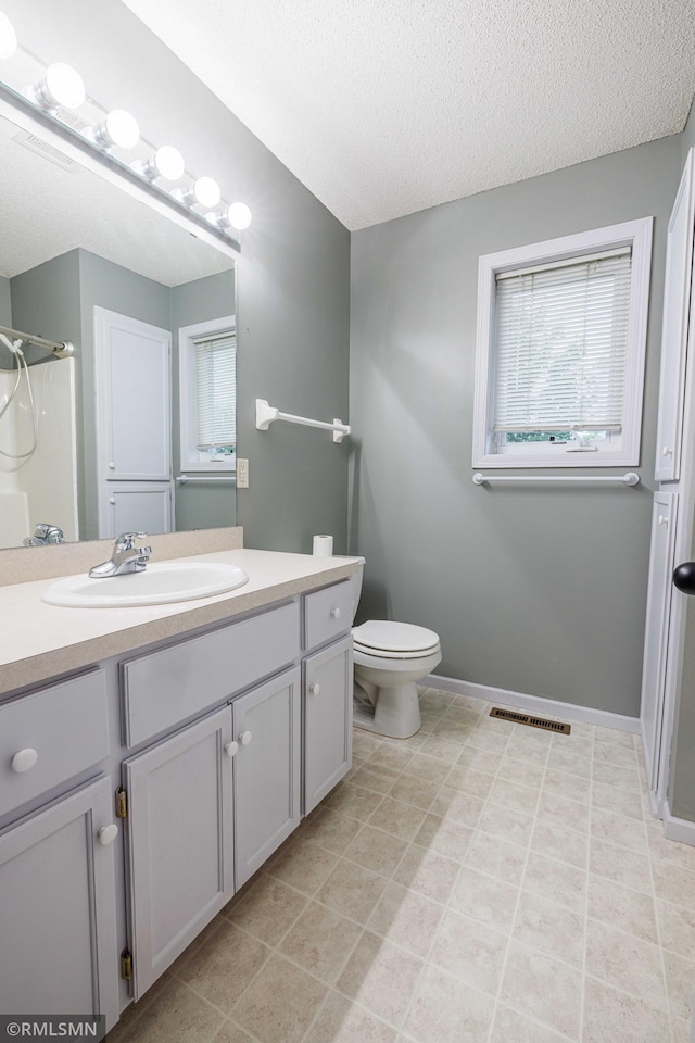 6354 151st Street Ct N, Hugo, MN 55038 - full bathroom featuring vanity, a shower, a textured ceiling, and tile patterned flooring