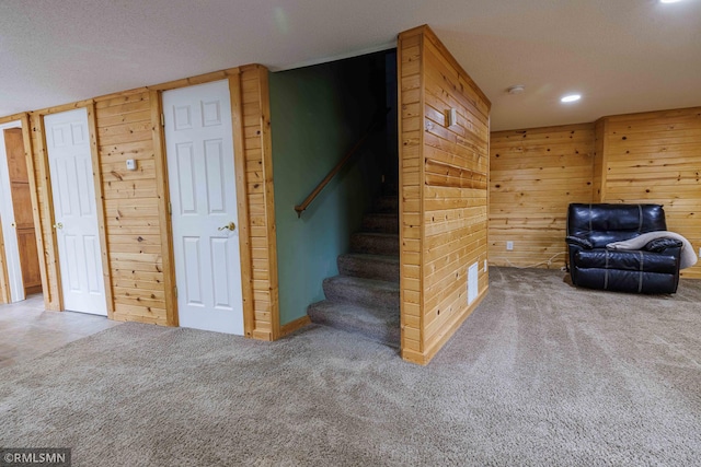6354 151st Street Ct N, Hugo, MN 55038 - staircase with wood walls, carpet flooring, recessed lighting, and a textured ceiling