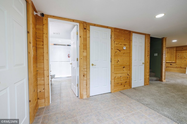6354 151st Street Ct N, Hugo, MN 55038 - hall featuring recessed lighting, light tile patterned flooring, wood walls, and light carpet