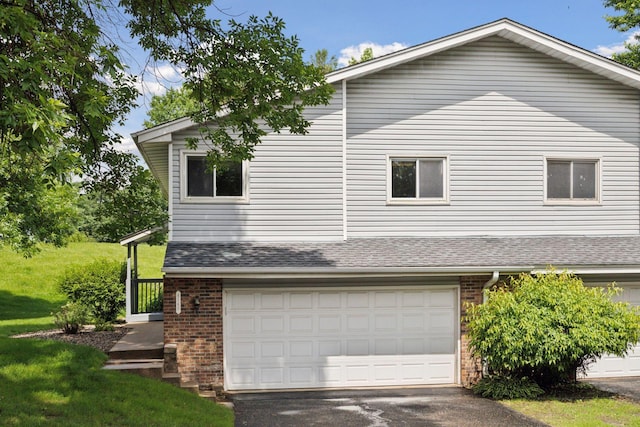 6160 Creek View Rdg, Minnetonka, MN 55345 - view of home's exterior with brick siding, a garage, asphalt driveway, roof with shingles, and a yard