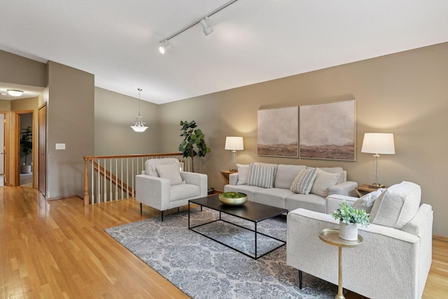 6160 Creek View Rdg, Minnetonka, MN 55345 - living area with light wood-style flooring, lofted ceiling, and track lighting
