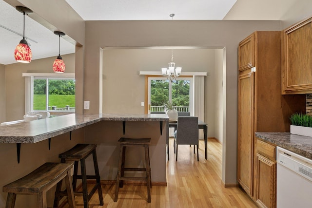 6160 Creek View Rdg, Minnetonka, MN 55345 - kitchen featuring white dishwasher, light wood finished floors, a breakfast bar, and a chandelier