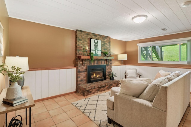 6160 Creek View Rdg, Minnetonka, MN 55345 - tiled living area featuring a wainscoted wall and a brick fireplace
