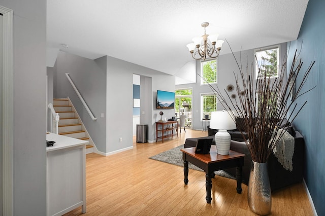6715 158th St W, Apple Valley, MN 55124 - living area featuring light wood-style floors, stairway, and a chandelier