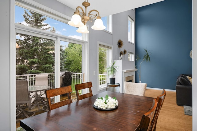 6715 158th St W, Apple Valley, MN 55124 - dining area with a chandelier, wood finished floors, and a fireplace