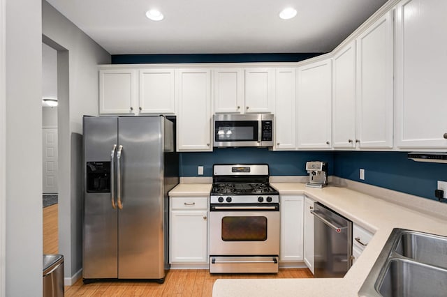 6715 158th St W, Apple Valley, MN 55124 - kitchen featuring appliances with stainless steel finishes, white cabinets, light wood-type flooring, light countertops, and recessed lighting