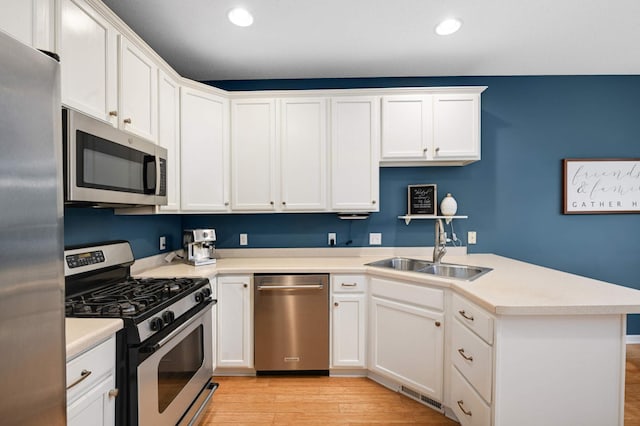 6715 158th St W, Apple Valley, MN 55124 - kitchen with appliances with stainless steel finishes, a peninsula, white cabinets, recessed lighting, and light countertops