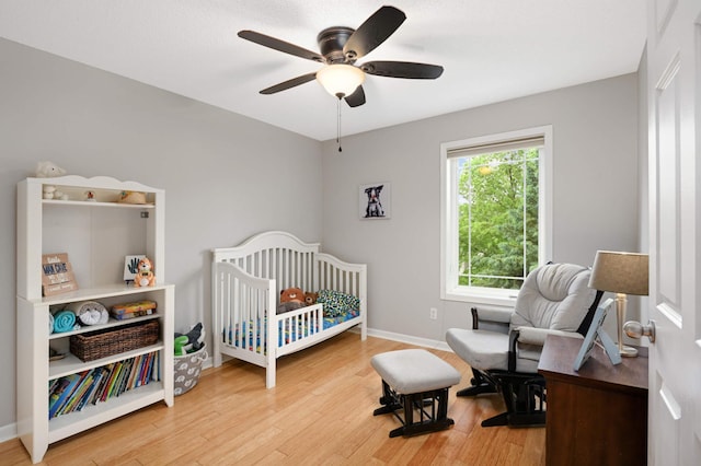 6715 158th St W, Apple Valley, MN 55124 - bedroom with wood finished floors, a crib, and ceiling fan
