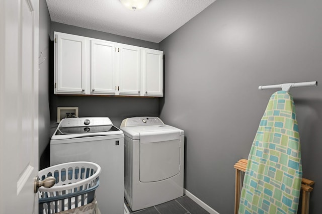 6715 158th St W, Apple Valley, MN 55124 - laundry room with washer and clothes dryer, cabinet space, and a textured ceiling