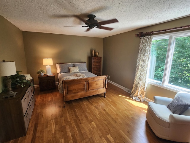 3900 Hillcrest Way, Deephaven, MN 55391 - bedroom featuring wood finished floors, a textured ceiling, and ceiling fan