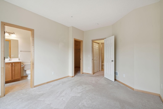 10751 Falling Water Ln Unit C, Woodbury, MN 55129 - unfurnished bedroom featuring light colored carpet, a spacious closet, and ensuite bathroom