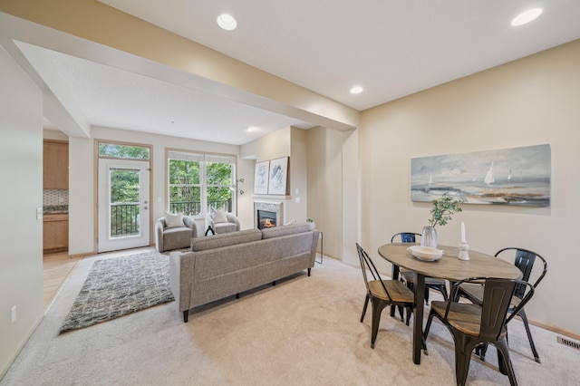 10751 Falling Water Ln Unit C, Woodbury, MN 55129 - living room featuring light carpet, a glass covered fireplace, and recessed lighting