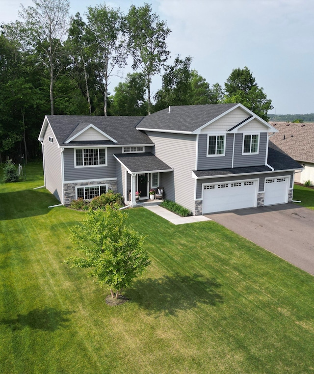 9147 Viking St, Brainerd, MN 56401 - view of front facade with stone siding, asphalt driveway, and a front lawn