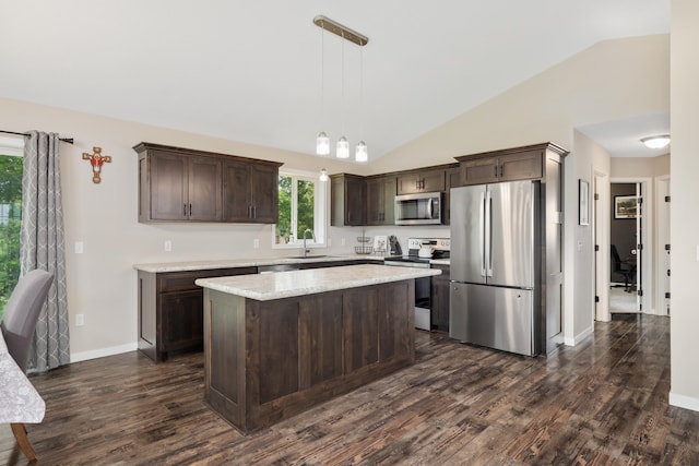 9147 Viking St, Brainerd, MN 56401 - kitchen featuring stainless steel appliances, dark brown cabinetry, lofted ceiling, dark wood-type flooring, and pendant lighting