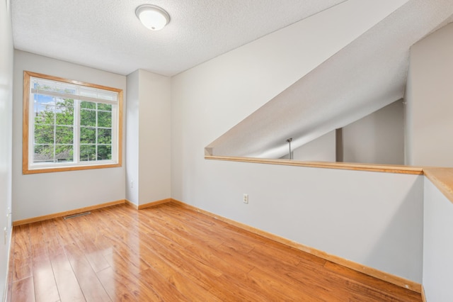 18267 Coneflower Ln, Eden Prairie, MN 55346 - unfurnished room with wood finished floors and a textured ceiling