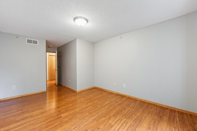 18267 Coneflower Ln, Eden Prairie, MN 55346 - unfurnished room featuring light wood-style floors and a textured ceiling