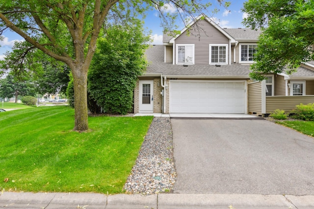 18267 Coneflower Ln, Eden Prairie, MN 55346 - view of front facade featuring asphalt driveway, a garage, a front yard, a shingled roof, and brick siding