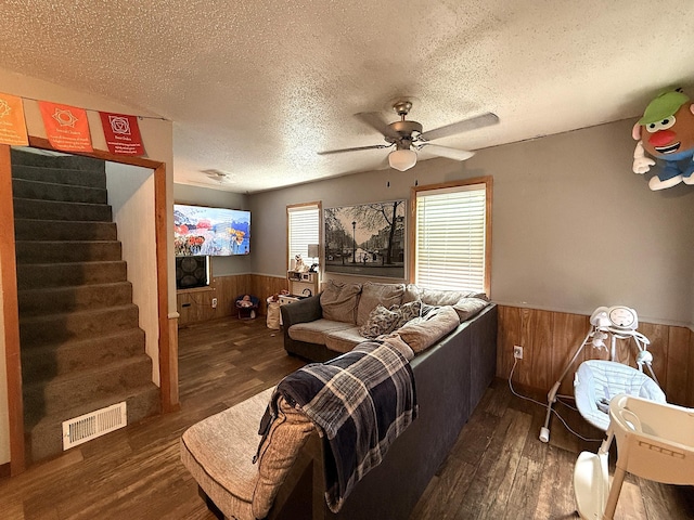 835 9th Ave, Granite Falls, MN 56241 - living room featuring a wainscoted wall, a textured ceiling, wood finished floors, wood walls, and a ceiling fan