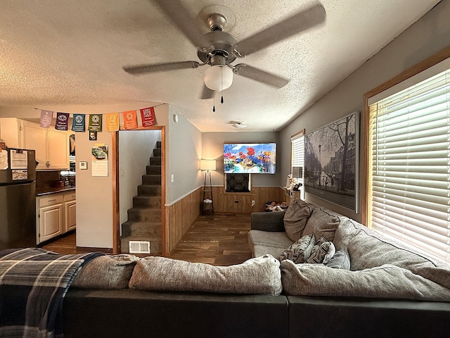 835 9th Ave, Granite Falls, MN 56241 - living room with a wainscoted wall, a textured ceiling, ceiling fan, dark wood-style floors, and stairway
