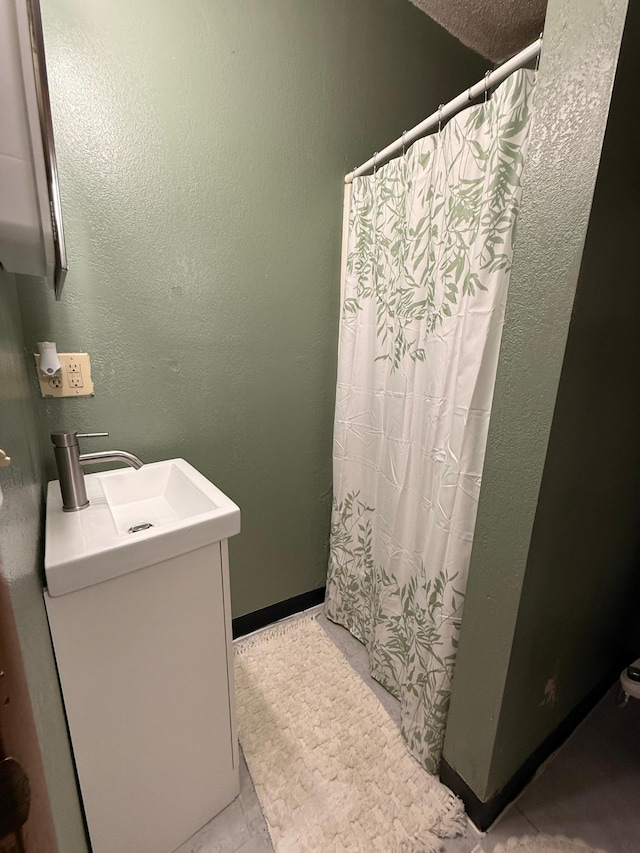 835 9th Ave, Granite Falls, MN 56241 - full bathroom featuring vanity, curtained shower, and a textured wall