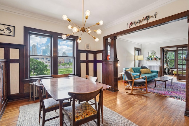 1718 Clinton Ave Unit 6, Minneapolis, MN 55404 - dining space with ornamental molding, light wood-type flooring, and a chandelier