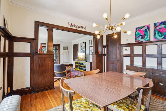 1718 Clinton Ave Unit 6, Minneapolis, MN 55404 - dining area featuring ornamental molding, radiator heating unit, light wood-style flooring, and a chandelier