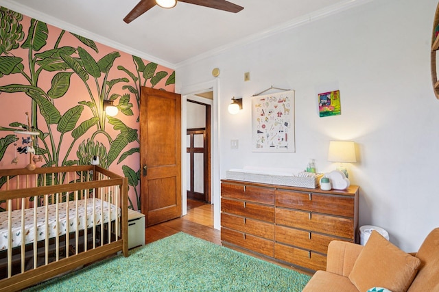 1718 Clinton Ave Unit 6, Minneapolis, MN 55404 - bedroom with wood finished floors, crown molding, and a ceiling fan