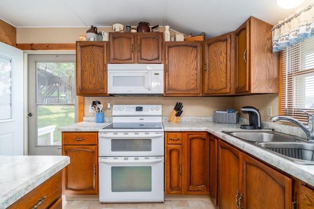 13506 Elmer Hanson Dr SE, Woodside Twp, MN 56736 - kitchen with white appliances, light countertops, and brown cabinets